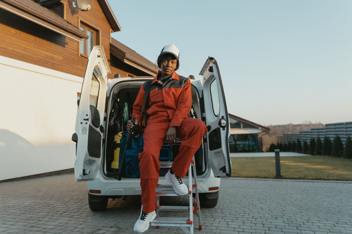 HVAC technician at an open service van in a driveway